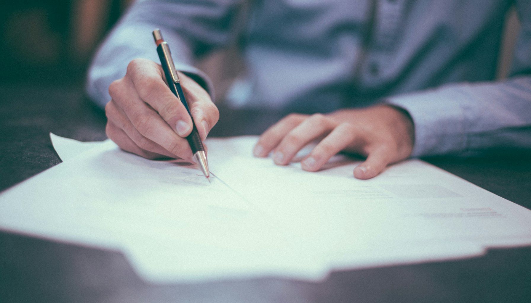 Professional woman reviewing legal documents about bailiff fees at modern office desk